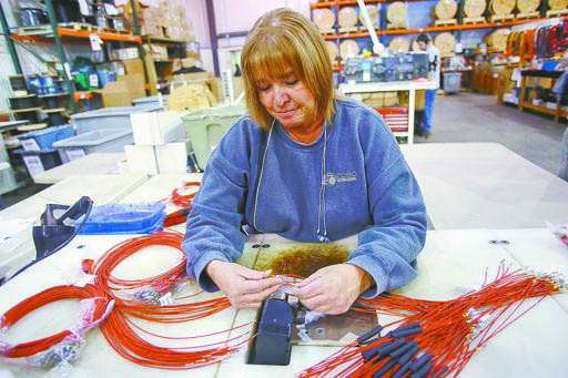 GINA LEDUC SPLICES WIRES WEDNESDAY TO BE USED IN THE ENGINE OF A C&H FORKLIFT AT COBO INTERNATIONAL IN BURLINGTON